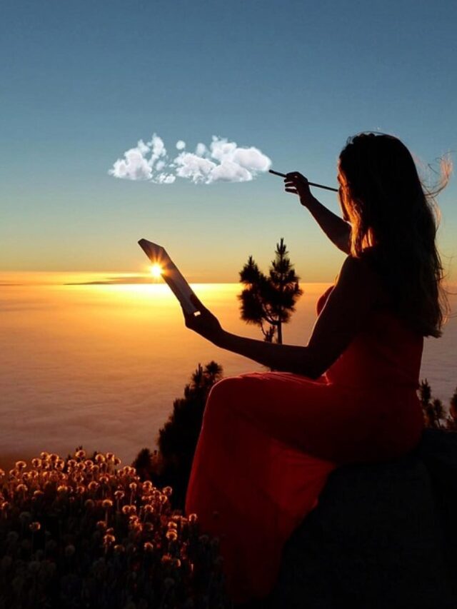 A woman painting a beautiful scene.